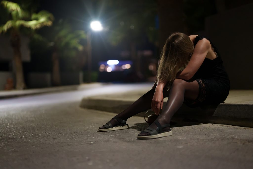Drunk Woman on curb - Disease Model of Addiction