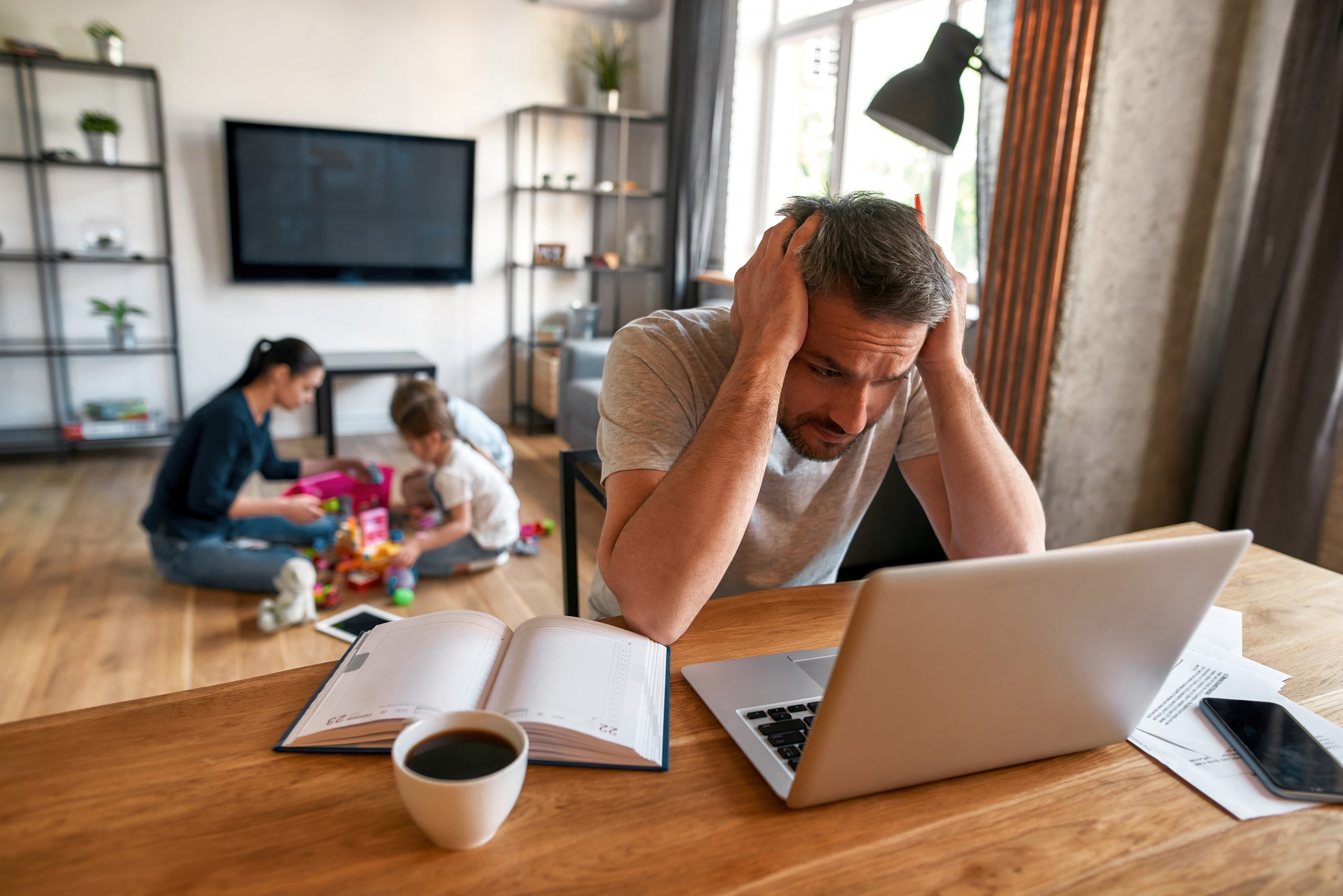 Man trying to use computer for online addiction treatment but is distracted