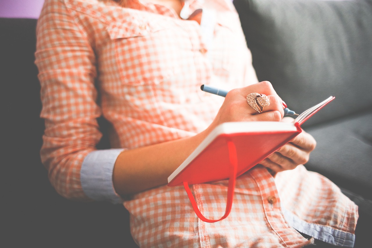 woman making a diary for mental health